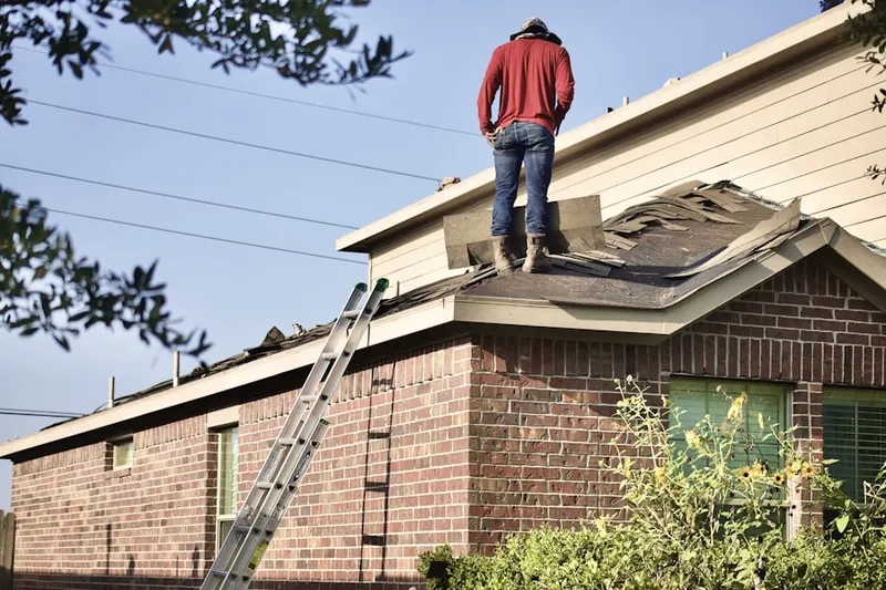 Professional roofer working on a residential roof in Northside
